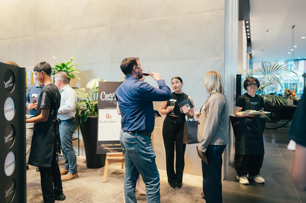 Charcoal, white, and gold branded displays and refined styling creating sophisticated networking environment