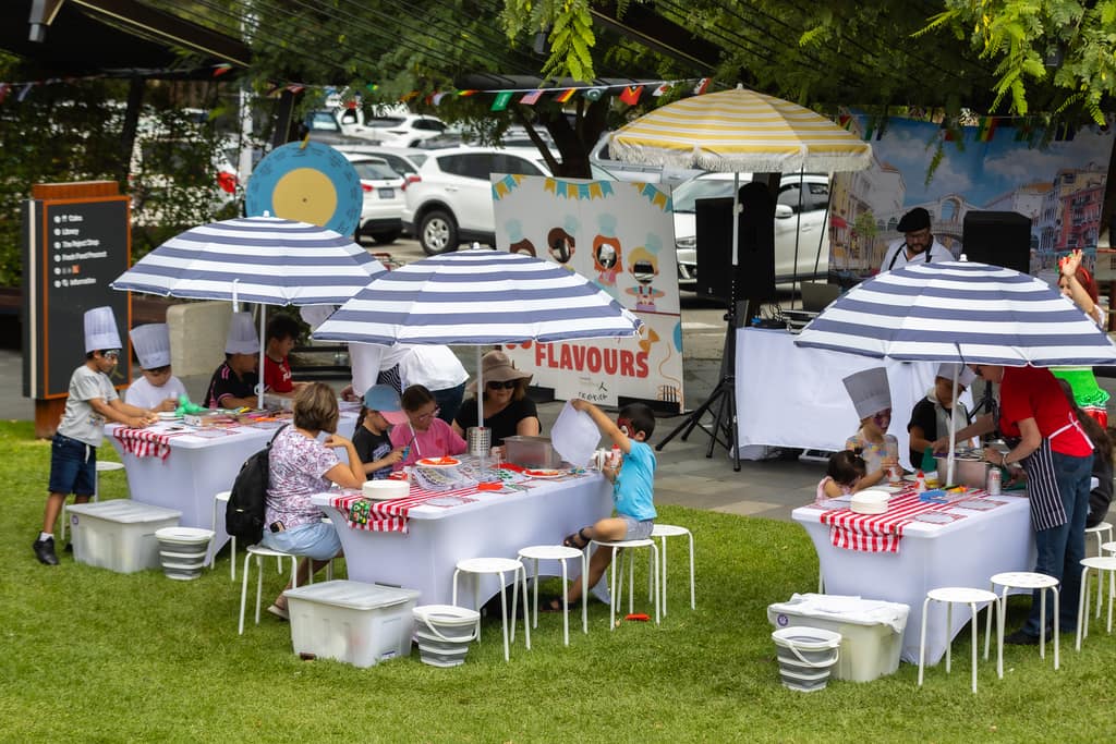 Kids craft workshops with mini chefs wearing personalised chef hats and aprons creating pizza, taco, or gelato crafts