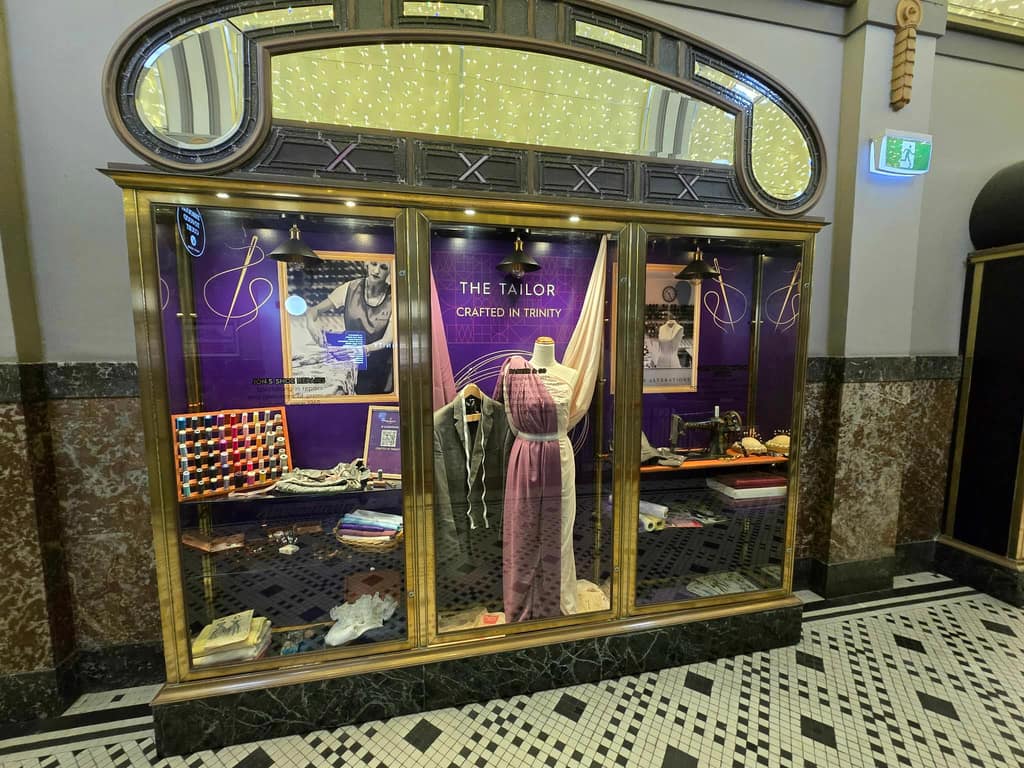 Tailor installation in Trinity Arcade with dress form, textiles, and sewing artefacts